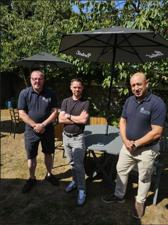 Members of the QRelia and Le Pommier partnership team together outdoors in Guernsey